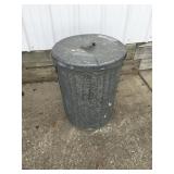 Galvanized trashcan with drilled holes in the
