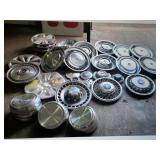 A LOT OF ABOUT 150 HUB CAPS- MANY OLD CADILLAC,