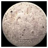 The coin is a heavily worn 1943 steel Lincoln Whea