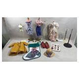collection of doll clothes and display forms,