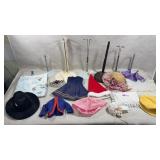 collection of doll clothes and accessories,