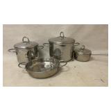 Four Stainless Steel Pots and Pans With Lids