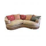 Curved Beige Sofa with Fringe and Throw Pillows
