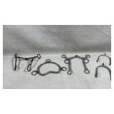 collection of Western horse bits and spurs