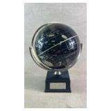 Black spinning world globe on base
