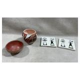 two square ceramic tiles decorated with