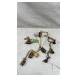 rustic hanging brass cowbells on a jute rope