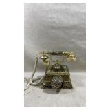 vintage, gold-toned rotary telephone designed in