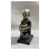 polyresin figurine of a kneeling monk or novice
