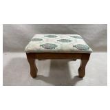vintage wooden footstool features a charming