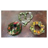 three decorative seasonal wreaths