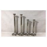 Four Metal Candle Holders In Graduated Sizes