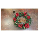 artificial Christmas wreath features vibrant red