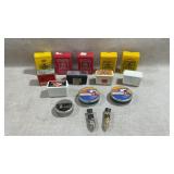 assortment of vintage air gun pellet containers,
