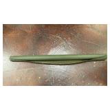 rolled-up piece of dark green woven fabric or