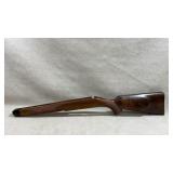 wooden rifle stock with a Monte Carlo style