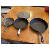 3 cast iron skillets and cast iron lid