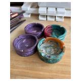 FOUR RESIN ASHTRAYS
