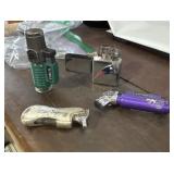 THREE BUTANE LIGHTERS AND PATRIOT LIGHTER