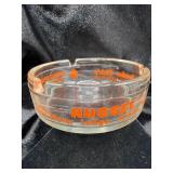 VINTAGE GLASS ASHTRAY FEATURING TRADER DICKS IN