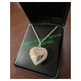 heart shaped locket, silver colored with clear