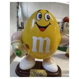 Yellow M & K candy dispenser