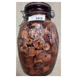 Colored Glass Jar full of Wooden Spools