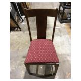 Wooden chair with red cushion