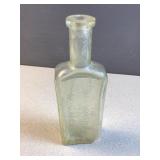 Antique glass bottle embossed ' for Rgeumatism