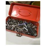 Orange metal tool box filled with sockets Orange metal tool box filled with sockets