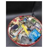Tin full of sewing supplies