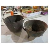 (2) CAST IRON POTS - ONE HAS CRACK