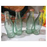 COLLECTION OF VINTAGE GREEN COKE BOTTLES