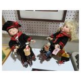 PAIR OF PORCELAIN DOLLS ON TRICYCLES