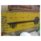 LARGE METAL KEY MOUNTED ON BOARD