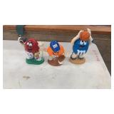 Three M&M candy dispensers