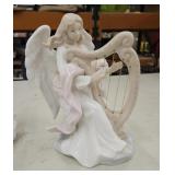 Angel sculpture playing a harp. Material: