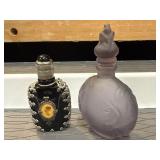 Vintage black glass perfume bottle featuring an