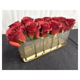 Res roses in a clear, rectangular acrylic vase.