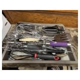A whole assortment of kitchen utensils some