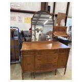 Vintage mahogany sideboard features a curved bow