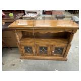 Vintage wood cabinet featuring leaded glass doors