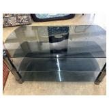 black and smoke-gray tri-level glass TV