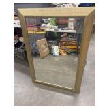 large, heavy wood-framed mirror with a distressed