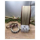 A gold-toned dainty chain, earrings and bracelets.