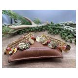2 brushed gold tone bangles feature dangling coin