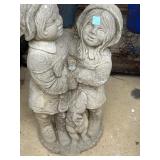 cast concrete garden statue of a boy and girl