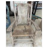 antique hickory rocking chair features a torn,
