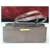 Estï¿½e Lauder burgundy satin cosmetic bag features