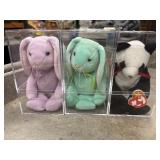 Three beanie babies in the protective cases, two